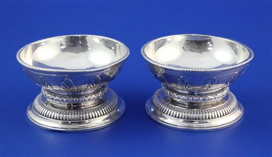 A pair of 1930s circular silver table salts by Tessiers Ltd, 19 oz.